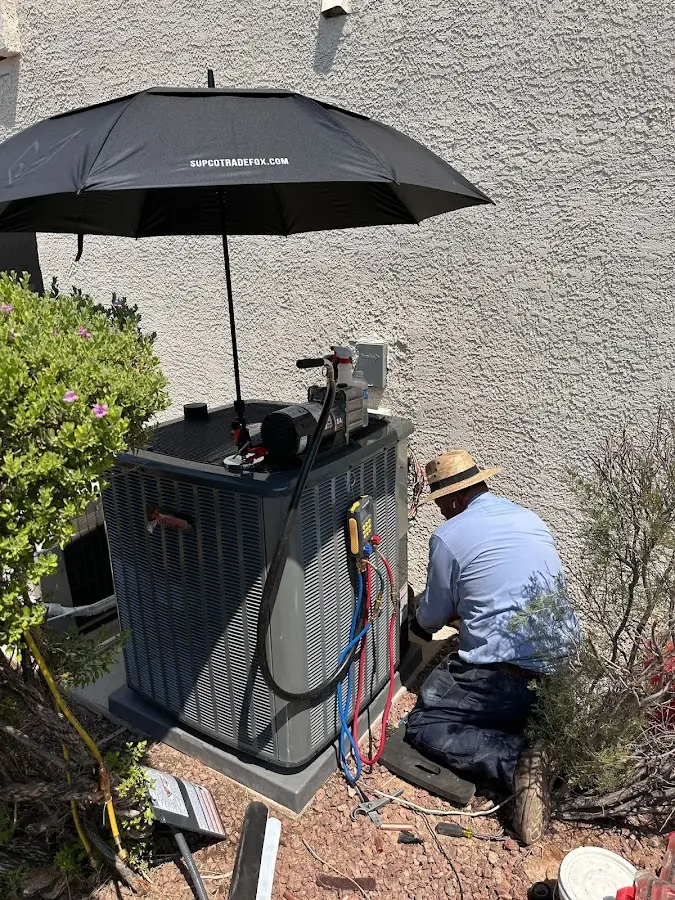 HVAC technician performing outdoor AC maintenance in Pell City
